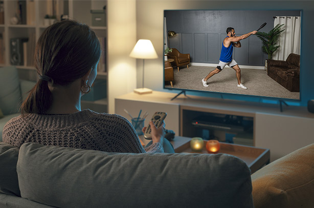 Zach demonstrating exercises seen on a TV screen